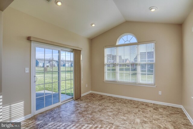 interior space featuring light tile patterned floors and vaulted ceiling