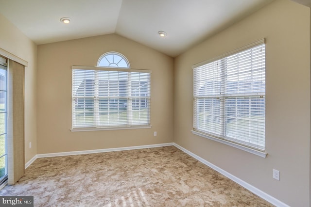 unfurnished room with a wealth of natural light and vaulted ceiling