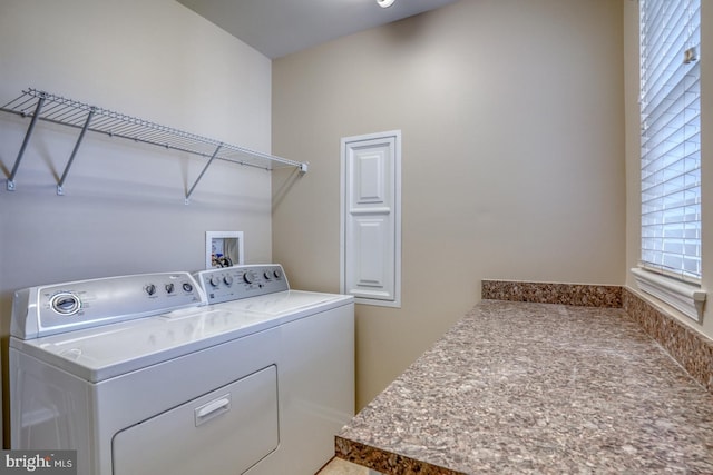 laundry area with washer and dryer and a healthy amount of sunlight