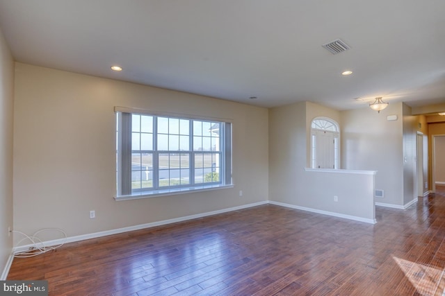 spare room with dark hardwood / wood-style flooring