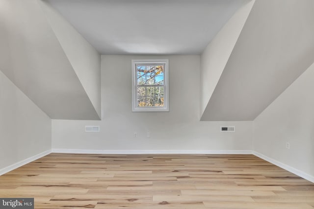 additional living space with light hardwood / wood-style floors