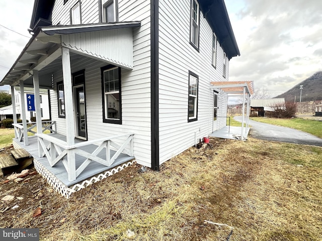 view of property exterior featuring covered porch