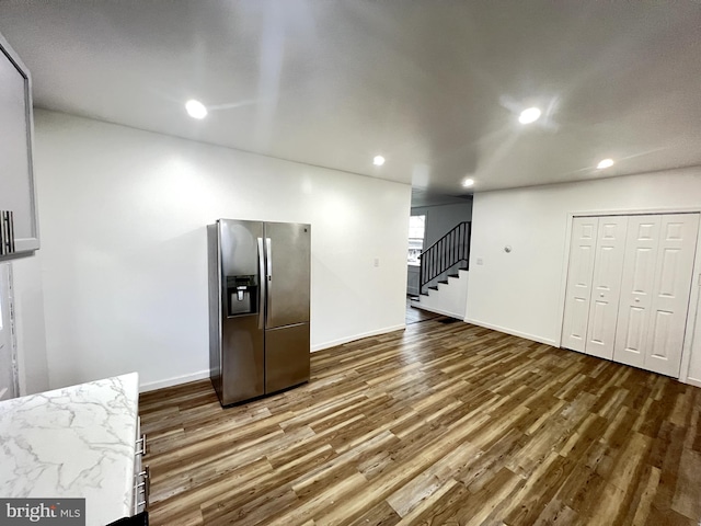 kitchen featuring stainless steel fridge and dark hardwood / wood-style flooring