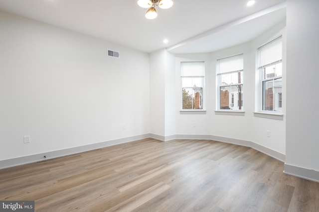 spare room featuring light wood-type flooring