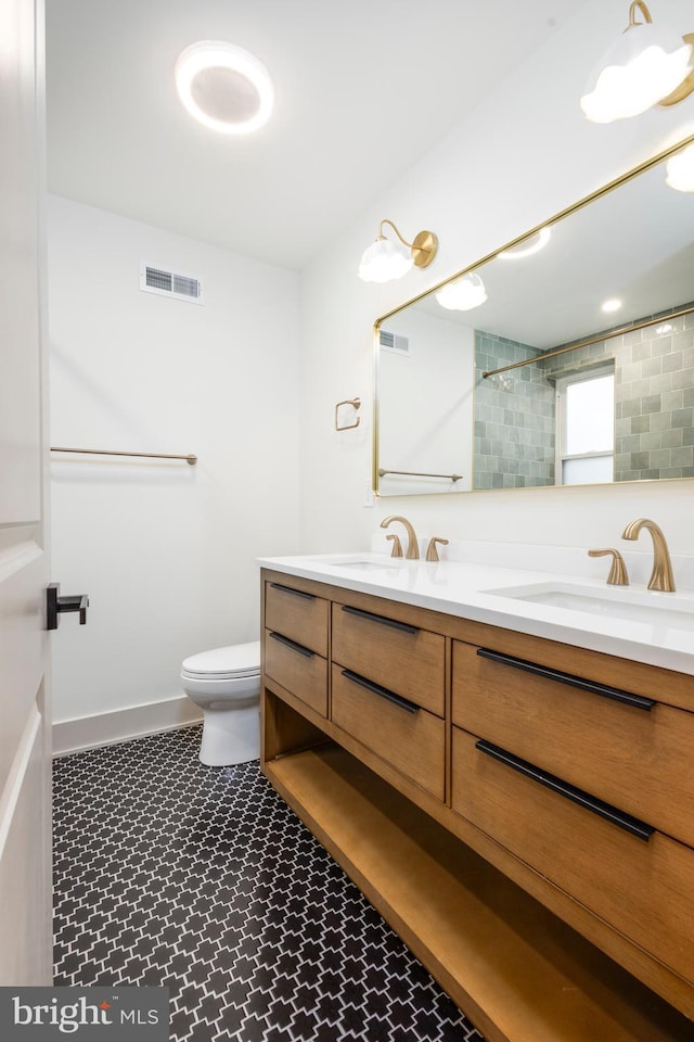 bathroom featuring vanity and toilet