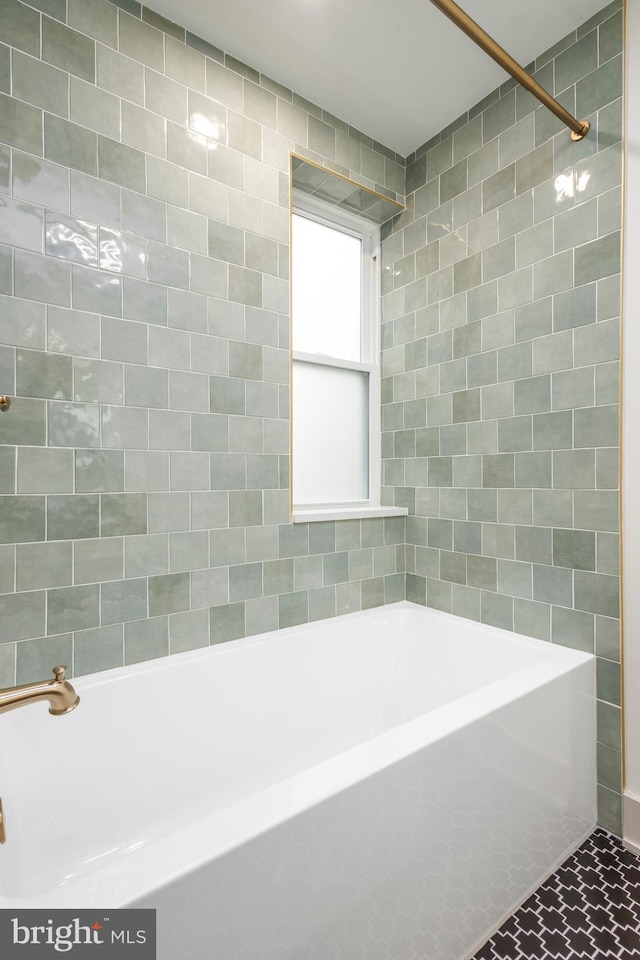 bathroom featuring tile patterned flooring and tiled shower / bath combo