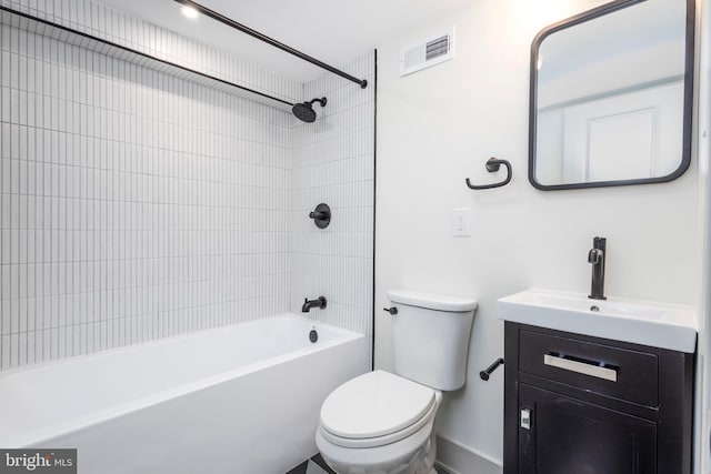 full bathroom featuring vanity, toilet, and tiled shower / bath