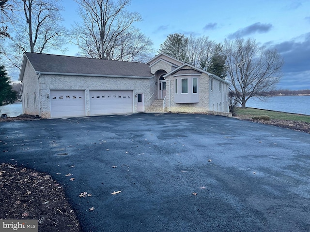 view of property featuring a water view and a garage