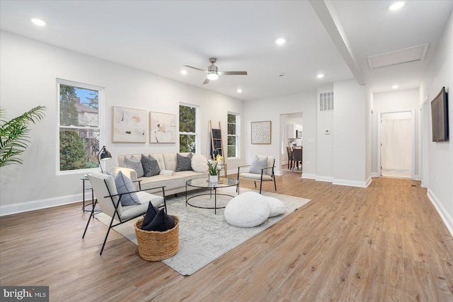 living room featuring ceiling fan and light hardwood / wood-style flooring