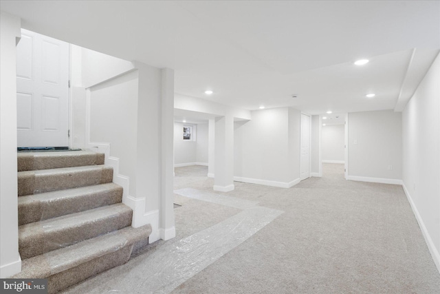 basement featuring light colored carpet