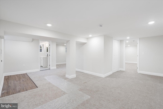 basement featuring light carpet