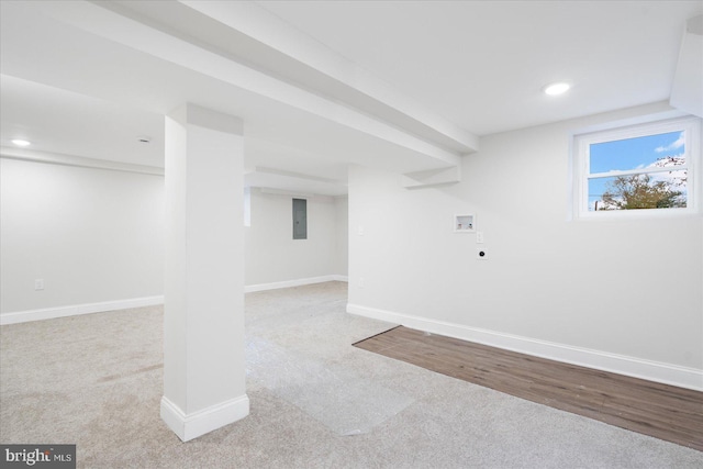 basement with light carpet and electric panel