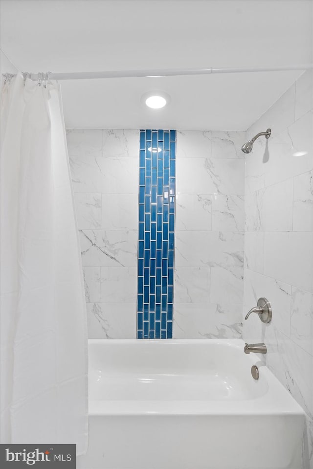 bathroom with shower / bath combination with curtain