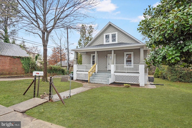 bungalow with a front yard and a porch