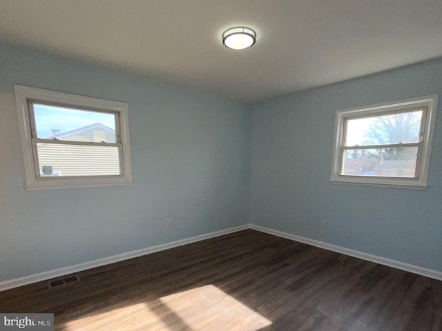 spare room featuring dark wood-type flooring