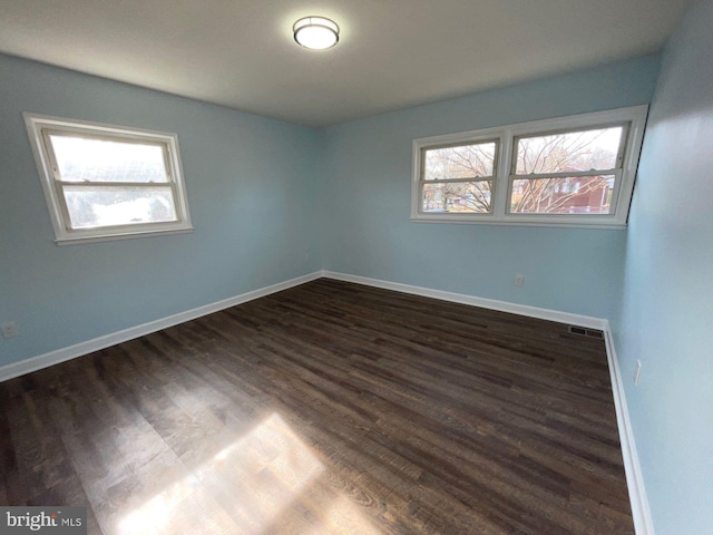 empty room featuring dark wood-type flooring