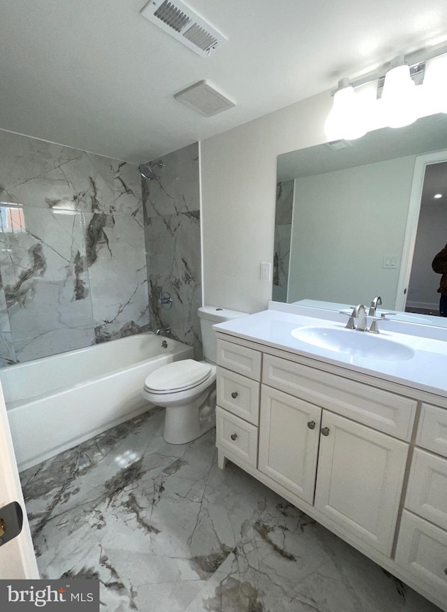 full bathroom featuring vanity, tiled shower / bath combo, and toilet