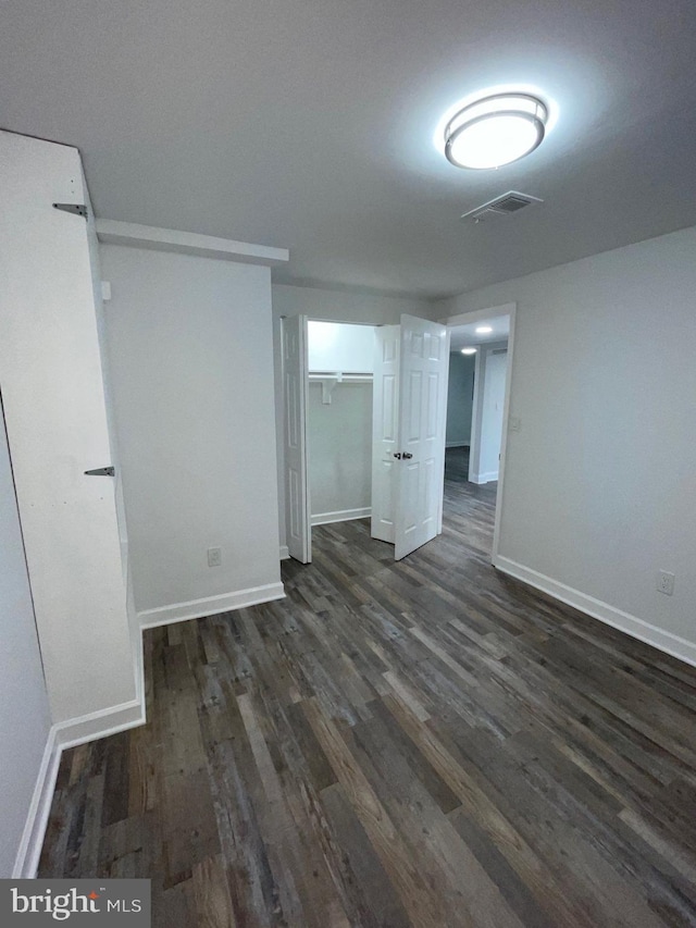 unfurnished room featuring dark hardwood / wood-style floors