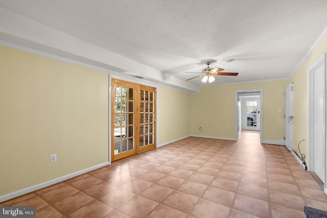 spare room featuring ceiling fan, baseboards, and ornamental molding