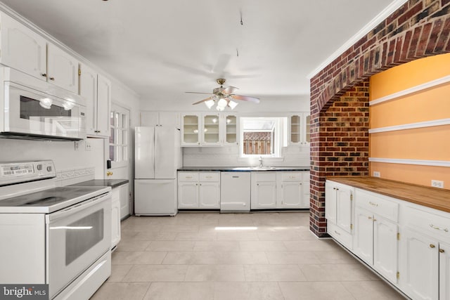 kitchen featuring white cabinetry, white appliances, glass insert cabinets, and brick wall