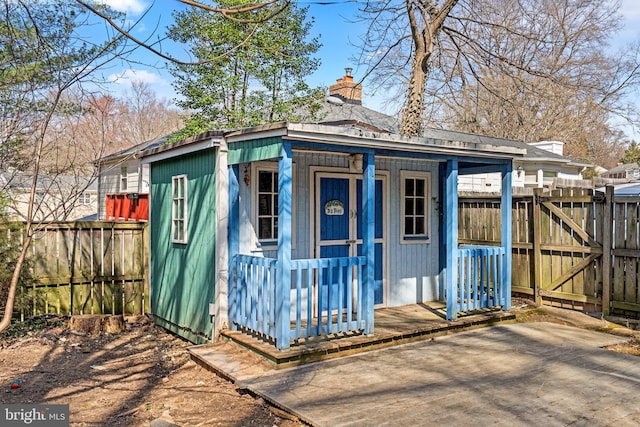 view of outbuilding featuring an outbuilding, a gate, and fence