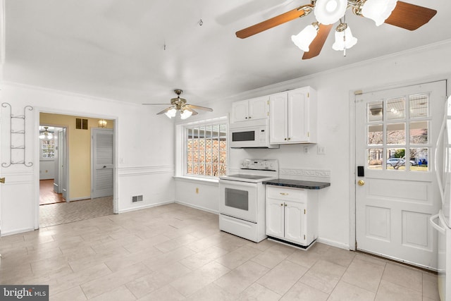 kitchen featuring white appliances, dark countertops, visible vents, white cabinetry, and crown molding