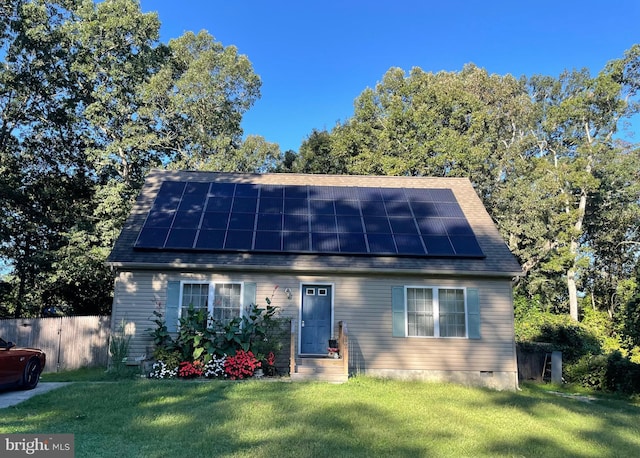 view of front of house featuring a front yard and solar panels