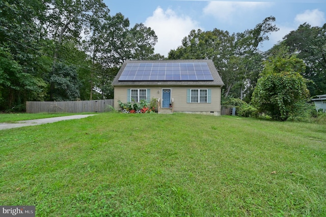 view of front of house featuring a front yard and solar panels