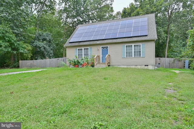 view of front of home with a front lawn and solar panels