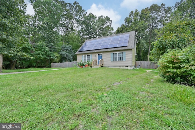 view of front of house featuring solar panels and a front yard