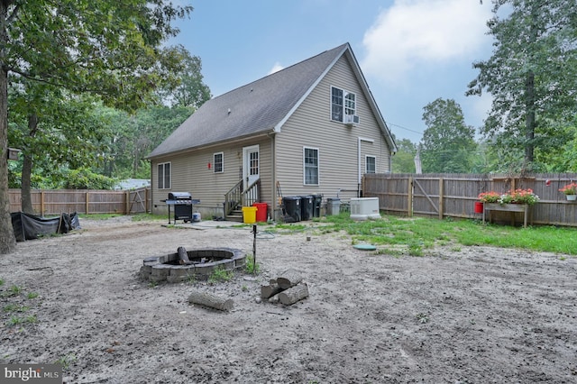 back of property featuring a fire pit