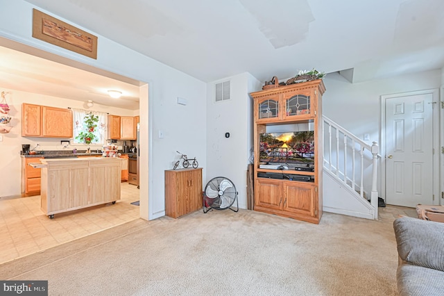 carpeted living room featuring sink