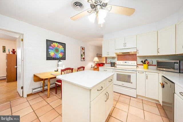 kitchen with a kitchen island, baseboard heating, stainless steel appliances, and white cabinetry