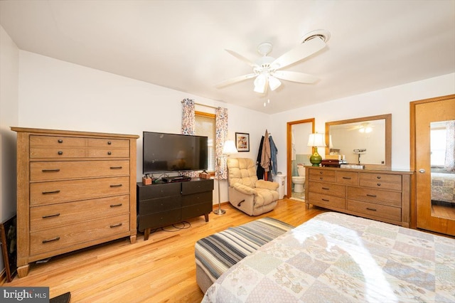 bedroom with ceiling fan, ensuite bath, and light hardwood / wood-style flooring