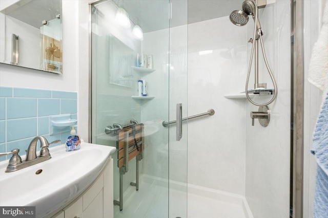 bathroom featuring vanity, tile walls, and walk in shower