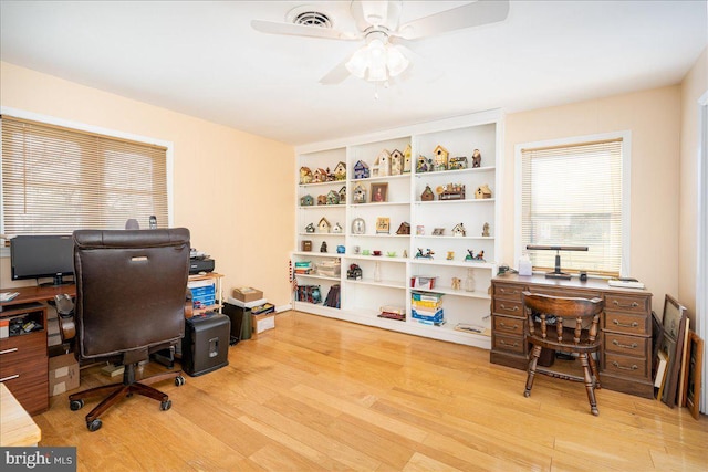 office area with light hardwood / wood-style flooring and ceiling fan