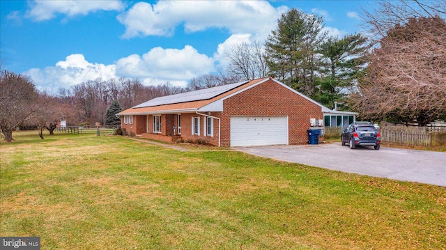 view of home's exterior featuring a lawn, solar panels, and a garage