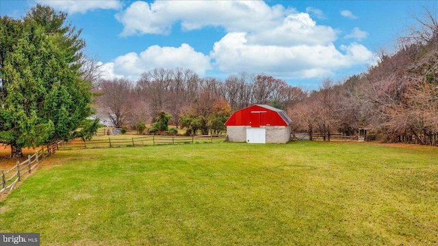 view of yard with a rural view and an outdoor structure