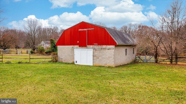 view of outdoor structure with a rural view and a lawn