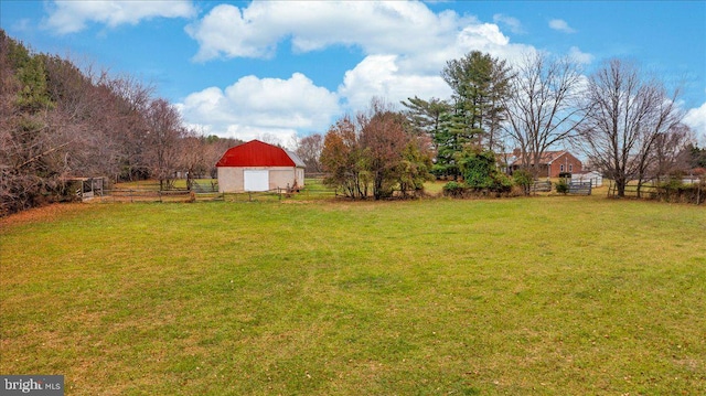 view of yard featuring a rural view and an outdoor structure