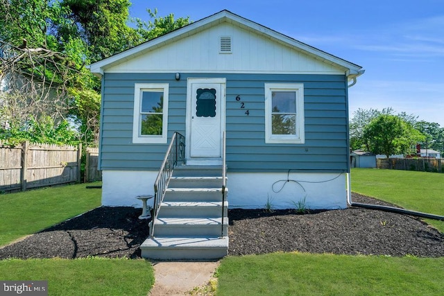 bungalow-style home featuring a front yard