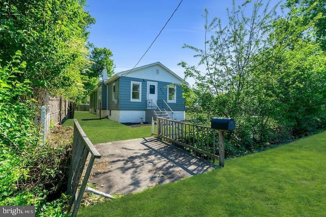 rear view of property with a lawn