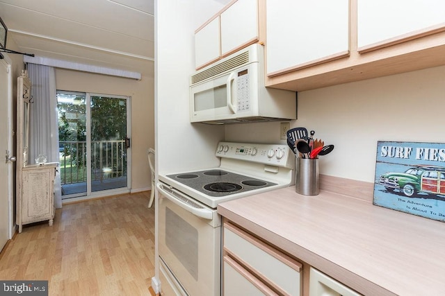 kitchen with white cabinetry, light wood-type flooring, and white appliances