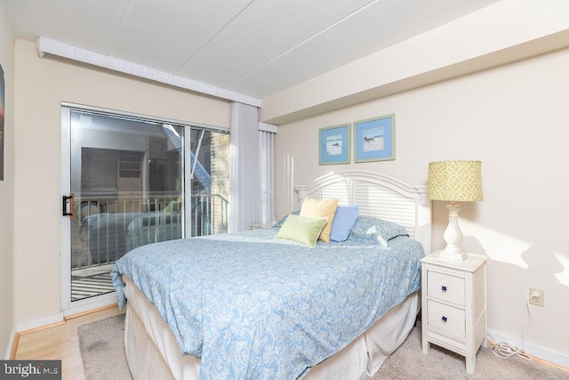 bedroom with light wood-type flooring and access to outside