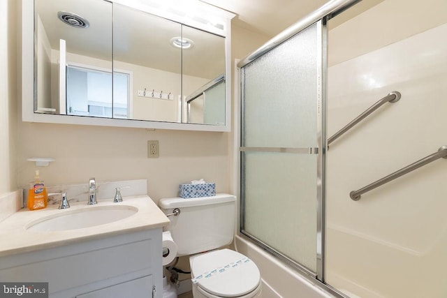 full bathroom with vanity, combined bath / shower with glass door, and toilet