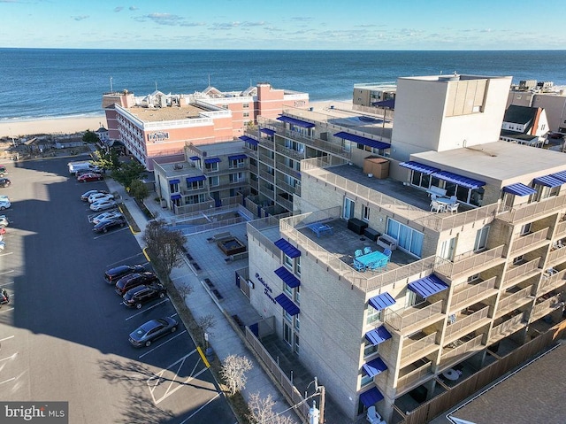 drone / aerial view with a water view and a beach view