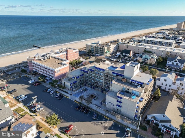 drone / aerial view with a beach view and a water view