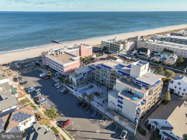 aerial view with a water view and a beach view