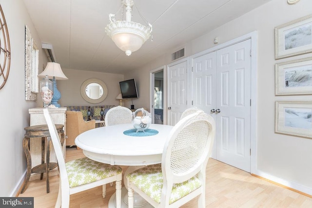 dining space with light hardwood / wood-style flooring