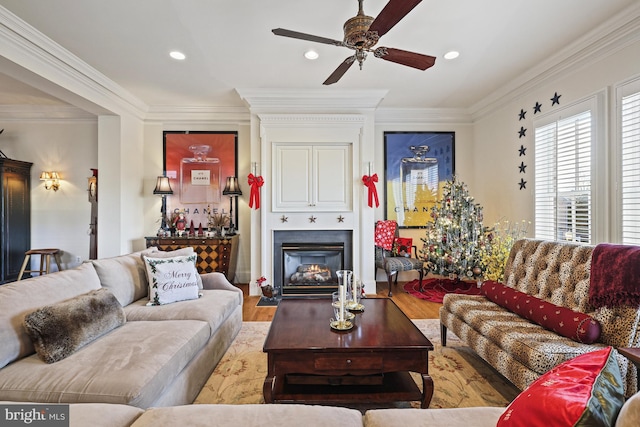 living room featuring ceiling fan, light hardwood / wood-style floors, and ornamental molding